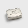 Silver matchbox with 'Spark a Revolution' text on a white background